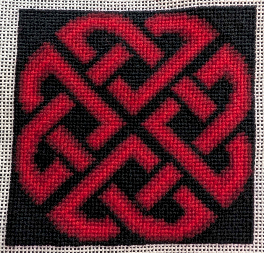 a red celtic knot on a black background