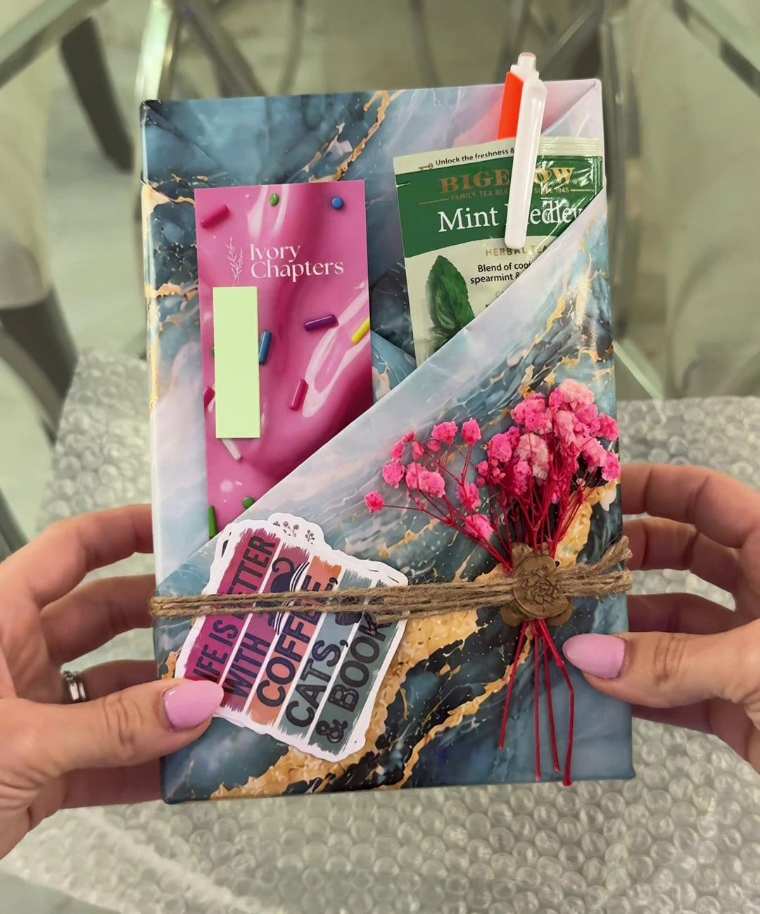 The wrapped book with twine, wax seal, and a dried flower