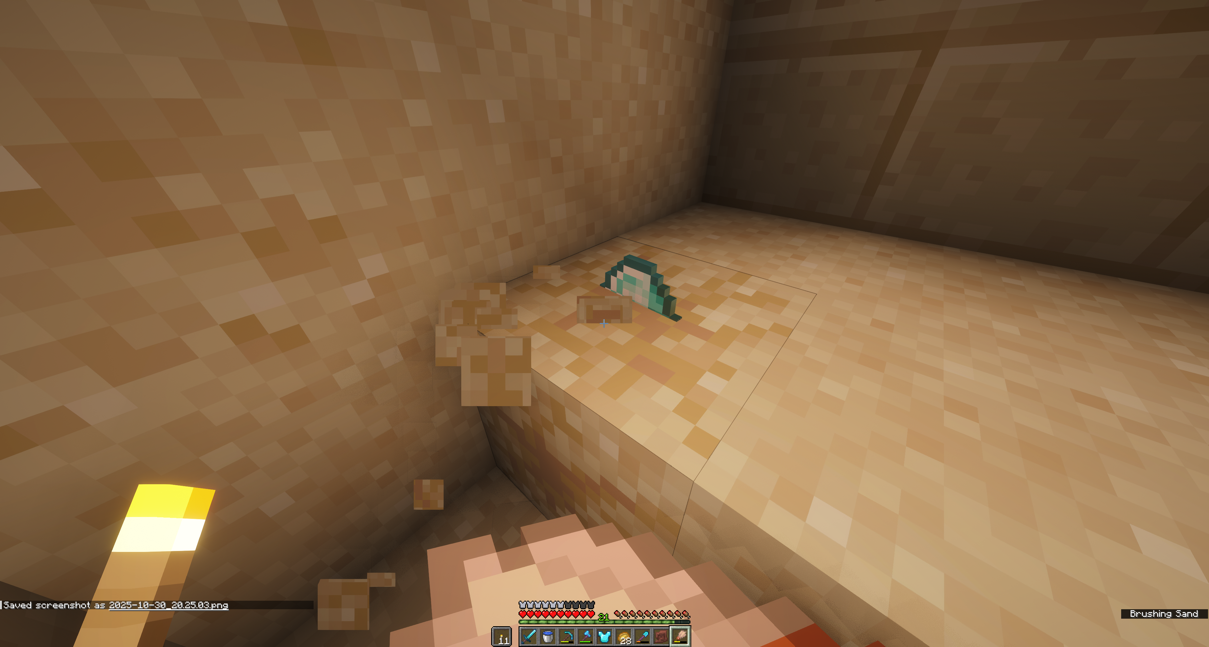 Brushing suspicious sand to reveal a diamond