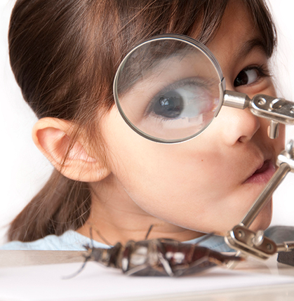 Young girl using a magnifying glass