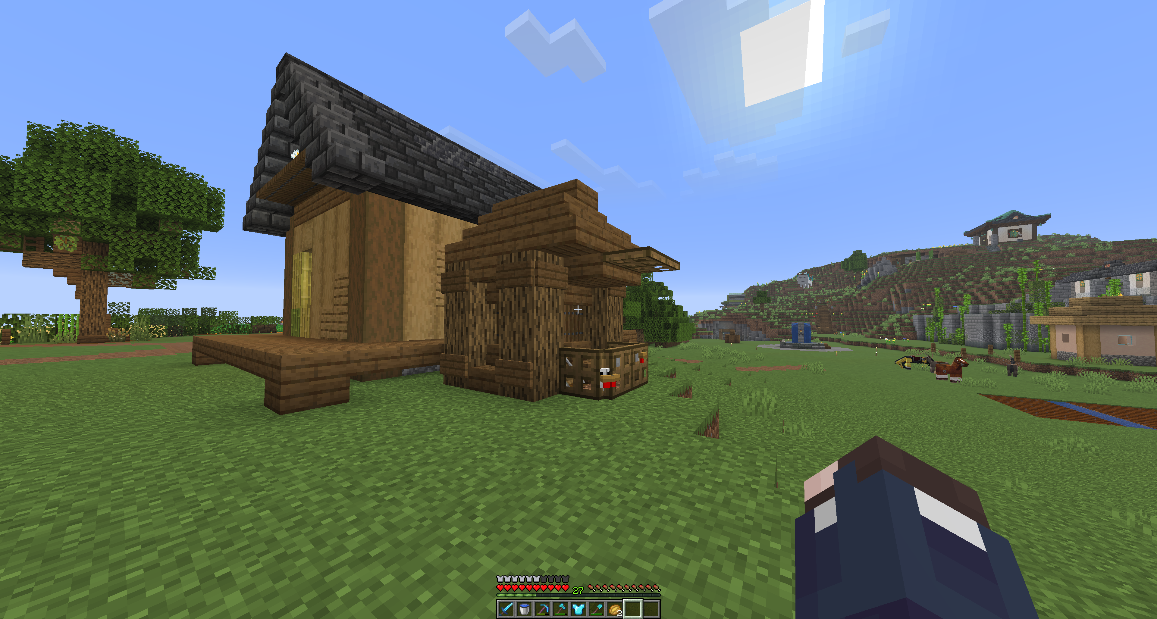 Chicken coop behind a house. There are chickens poking their faces through trap doors.