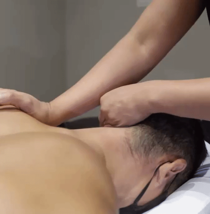 registered Massage Therapist treating back stiffness and back pain in Strength-N-U Fitness & Therapy Treatment room.