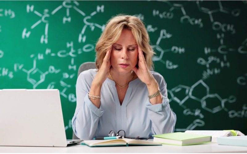 Stressed teacher at desk