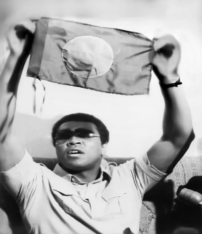Muhammad Ali Holding the Flag of Bangladesh at a press conference. Source: Md. Lutfor Rahman Binu